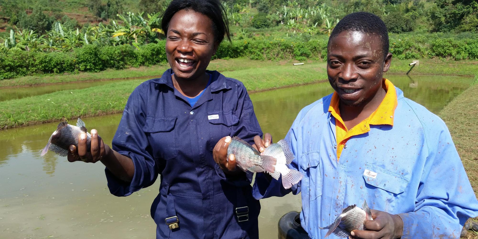 Two young farmers with fish